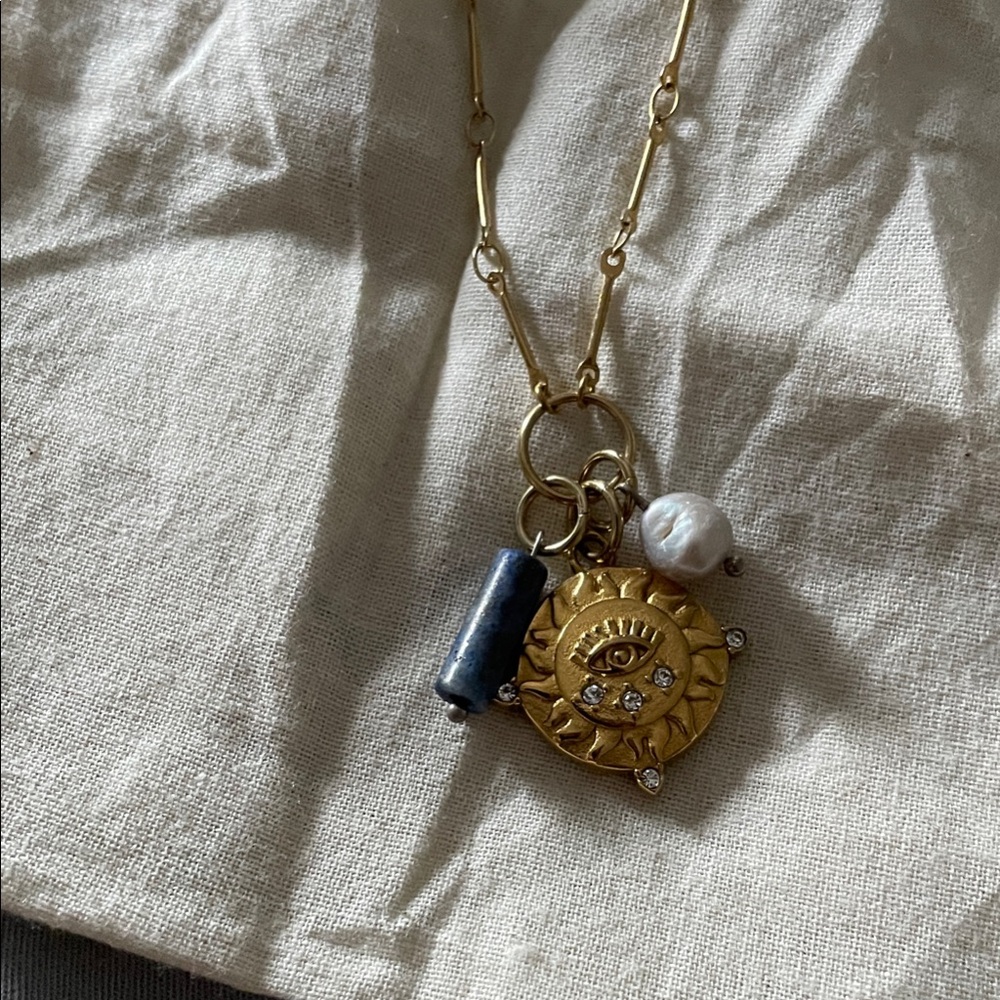 Gold Sun Eye Pendant Necklace with Blue Accent and White Pearl